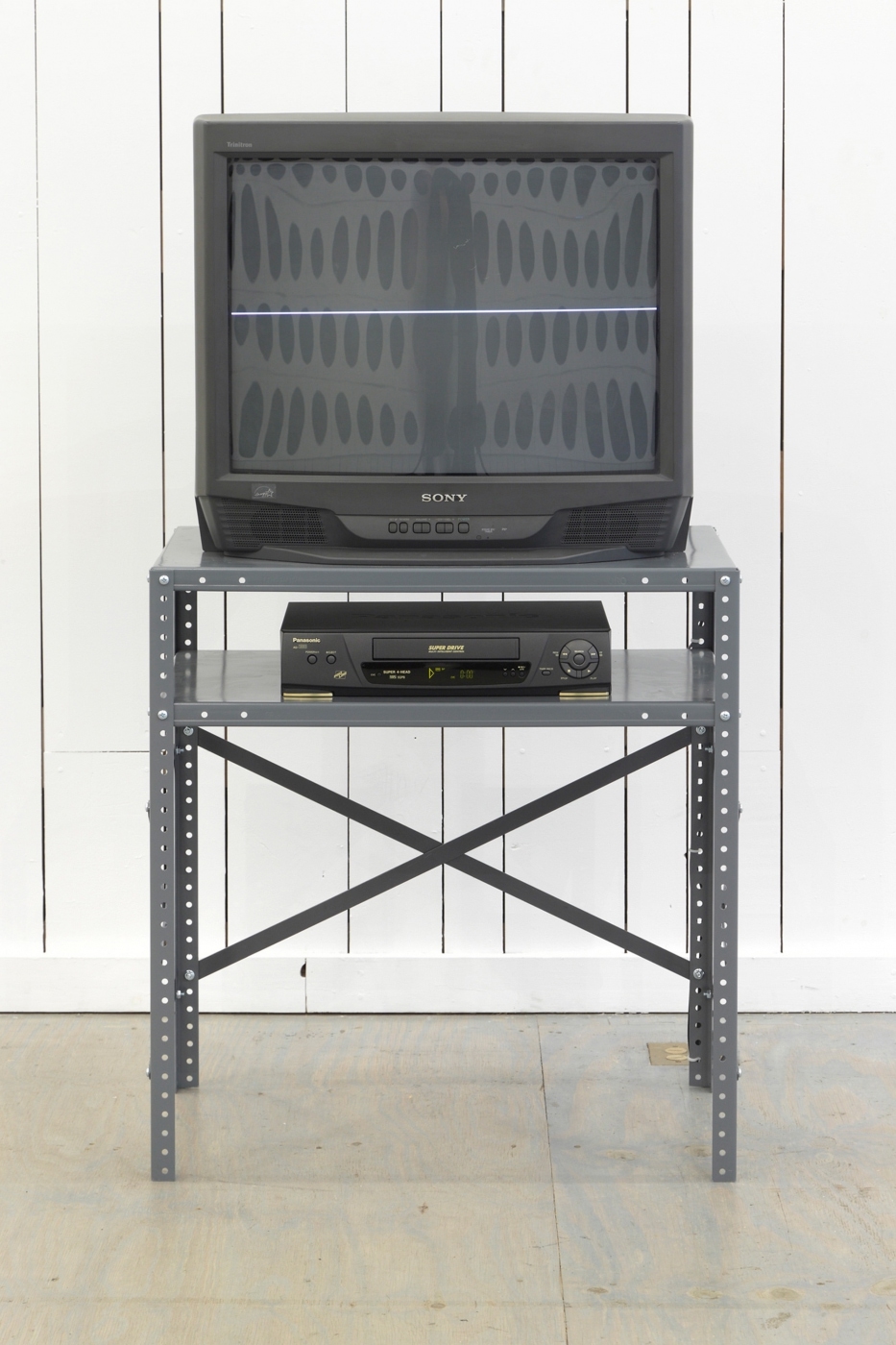 Line,1998,
Television, VCR, grey metal stand, VHS tape, 55 1/2 × 29 3/4 × 21 1/2 inches, continuous duration