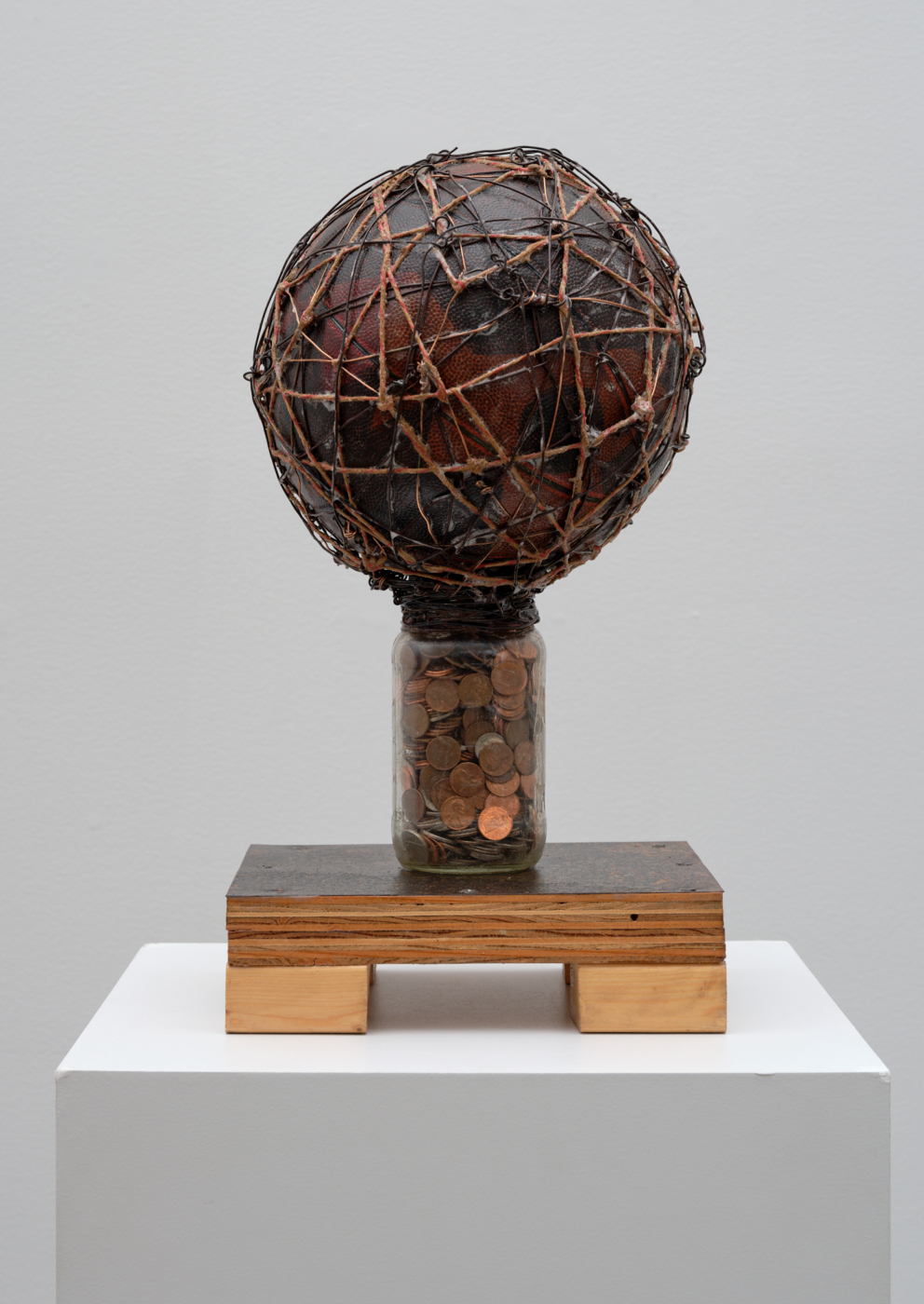 Small Change, 2001. Basketball, wire, rope, bottle, coins, metal, screws, wood and glue, 19 x 10 1/4 x 9 3/4 in. (48.26 x 26.04 x 24.77 cm)