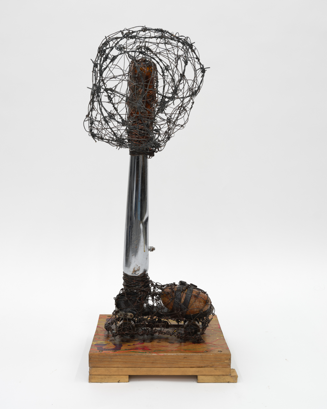 Two Buckles, One Foot, 2011. Barbed wire, wire, wood, glue, screws, stone, roller skate, paint, metal, and bottle, 36 x 15 x 11½ in. (91.44 x 38.10 x 29.21 cm)