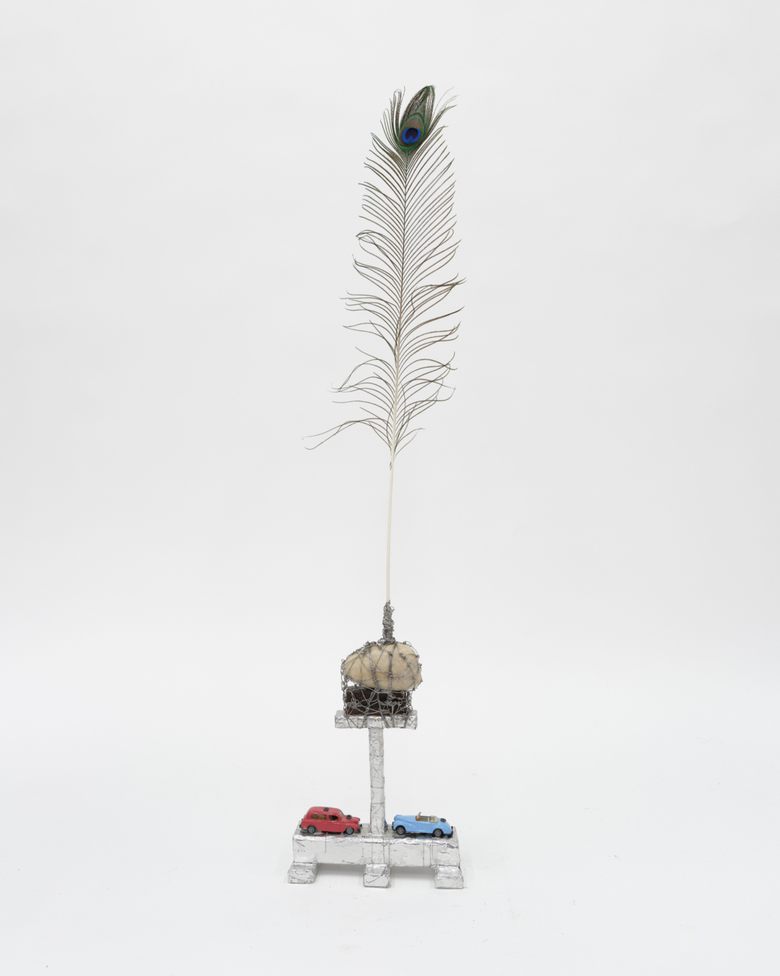 Monument to theLighthouse, 2024. Feather, wire, stone, metal, tin foil, toy cars, screws, wood and glue, 44 x 9⅝ x 5 inches (111.76 x 24.46 x 12.70 cm)