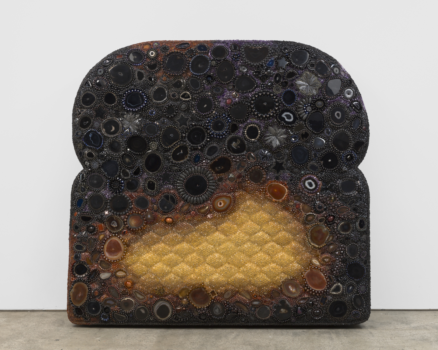 Starstruck, 2025. Agate, tektite, obsidian, amethyst, amber, pyrite, hematite, lapis lazuli, lava rock, black kyanite, smoky quartz, garnet, carnelian, jasper, tiger eye, wood, glass, acrylic, aluminum and steel pins on coated polystyrene, 77 x 80 x 20½ in. (195.58 x 203.20 x 52.07 cm)