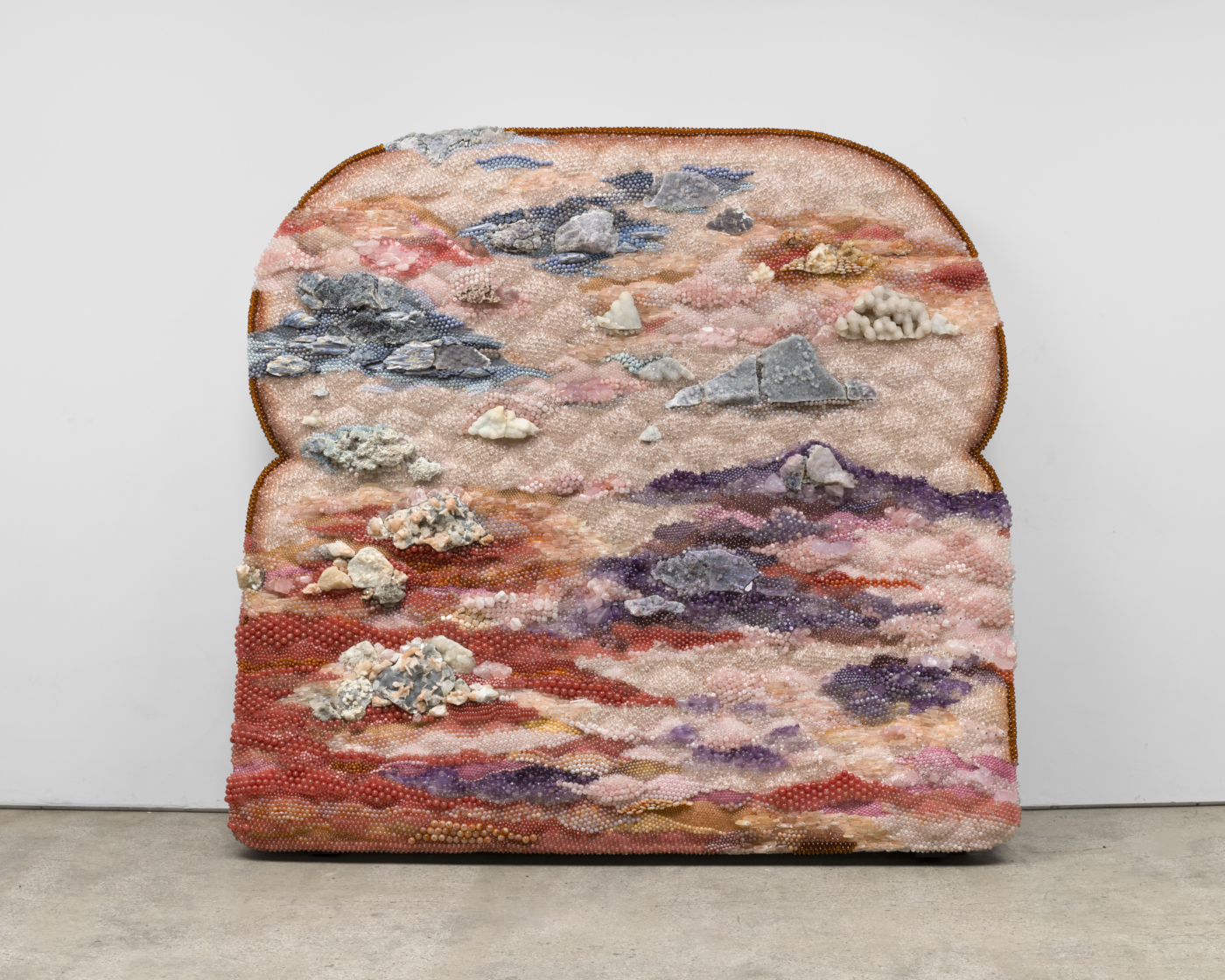 Sunset Strip, 2025. Amethyst, rose quartz, agate, calcite, chalcedony, kyanite, celestite, stilbite, apophyllite, aquamarine, rhodonite, sodalite, quartz, cherry quartz, glass, acrylic, aluminum and steel pins on coated polystyrene, 75½ x 81 x 25 in. (191.77 x 205.74 x 63.50 cm)