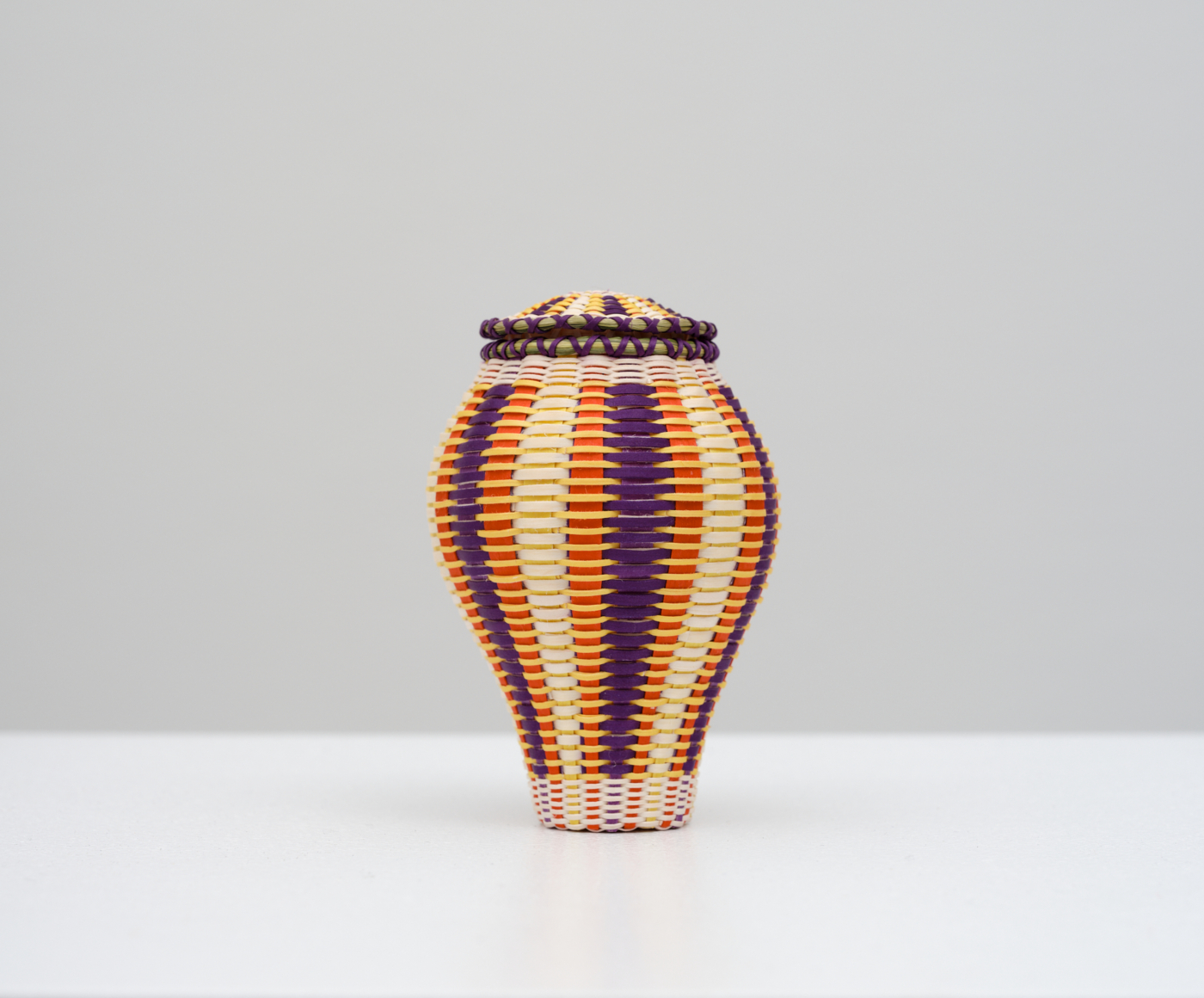 Jeremy Frey, Allusion, 2025. Black ash, sweetgrass, and synthetic dye, 4 x 2 3/4 x 2 3/4 in. (10.16 x 6.99 x 6.99 cm)