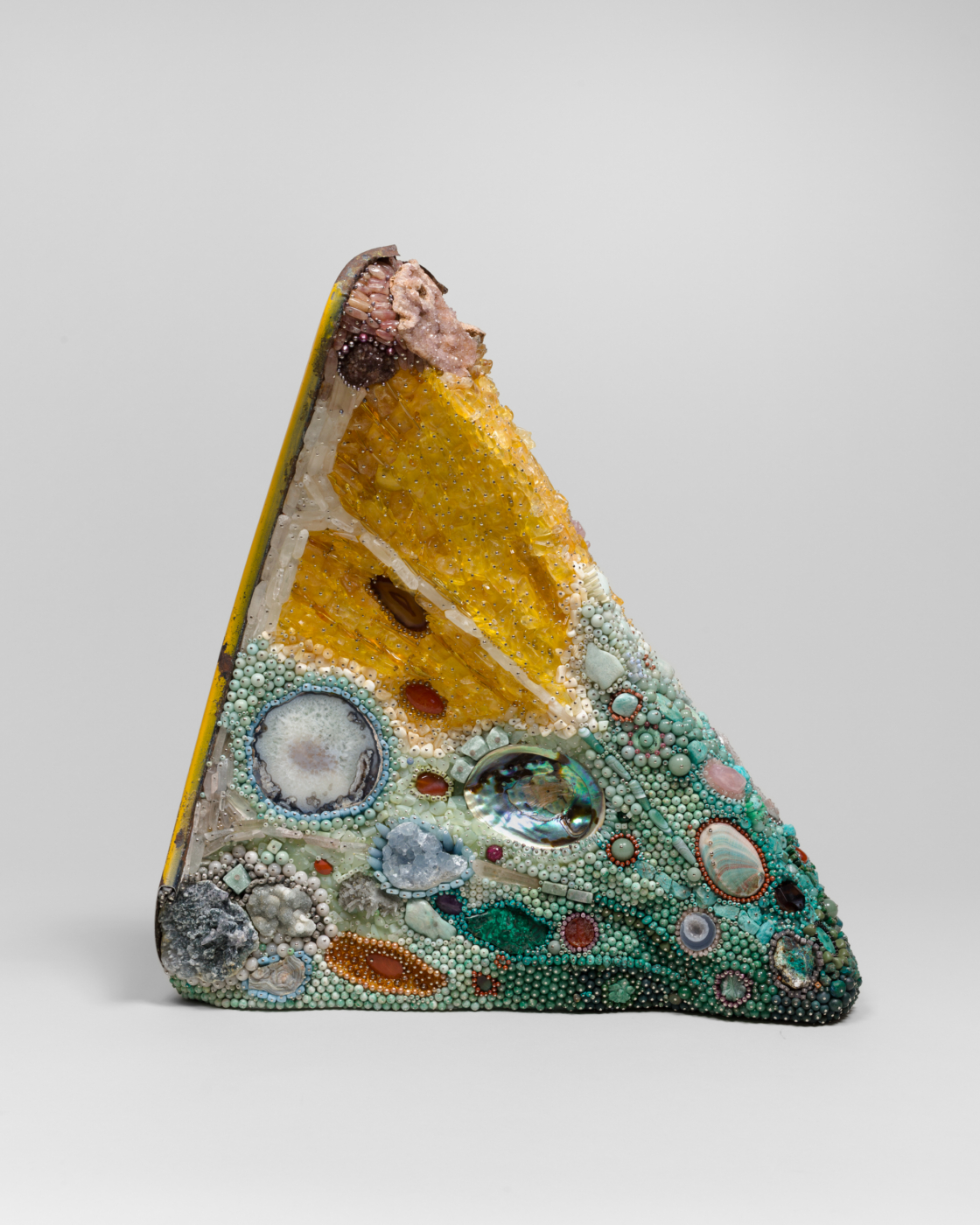 Kathleen Ryan, Bad Lemon (Adrift), 2026. Citrine, amazonite, agate, turquoise, malachite, aquamarine, pyrite, serpentine, rose quartz, quartz, celestite, jasper, amethyst, magnesite, aventurine, dolomite and fuchsite, amber, abalone, freshwater pearls, marble, glass, steel pins on coated polystyrene, and Volkswagen fender, 26 1/2 x 25 x 11 1/2 in. (67.31 x 63.50 x 22.86 cm)