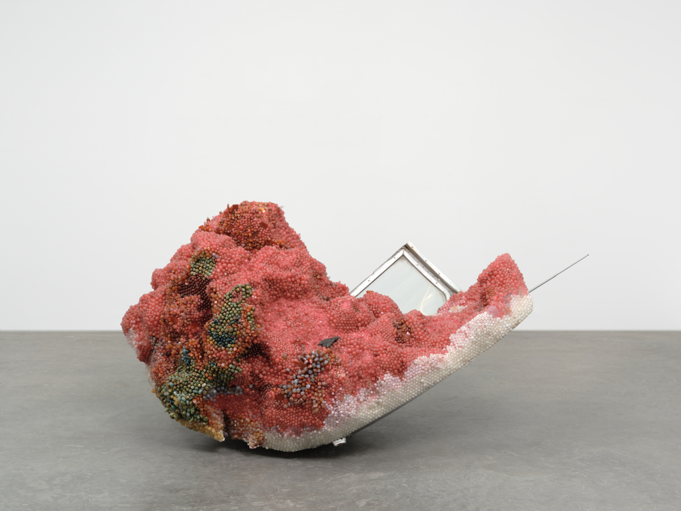 Kathleen Ryan, Bad Melon (Big Chunk), 2020. Cherry quartz, agate, smoky quartz, amazonite, jasper, aventurine, rhodonite, rhodochrosite, labradorite, quartz, Botswana agate, carnelian, glass, cast iron and brass flies, steel and stainless steel pins, polystyrene, and aluminum Airstream, 34¼ x 67¼ x 55½ in. 